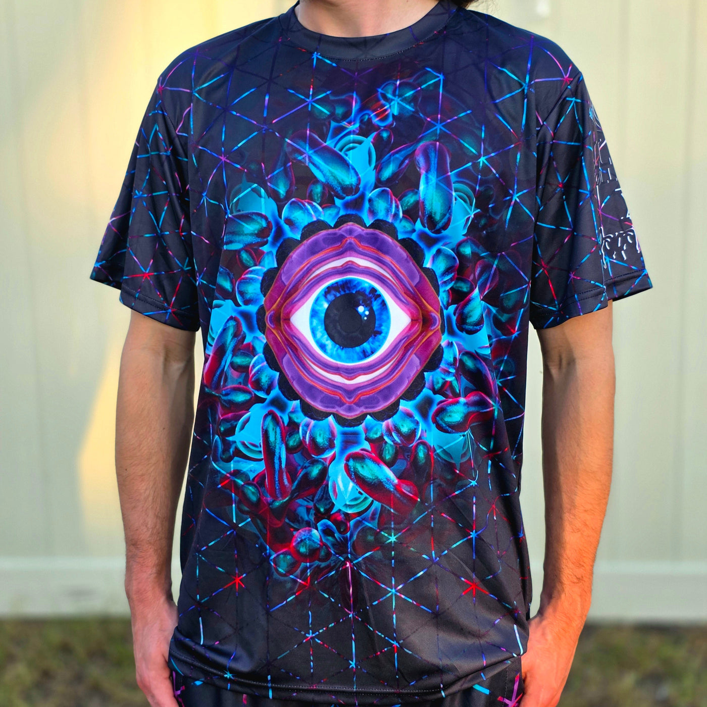 Person wearing a t-shirt with a colorful eye design
